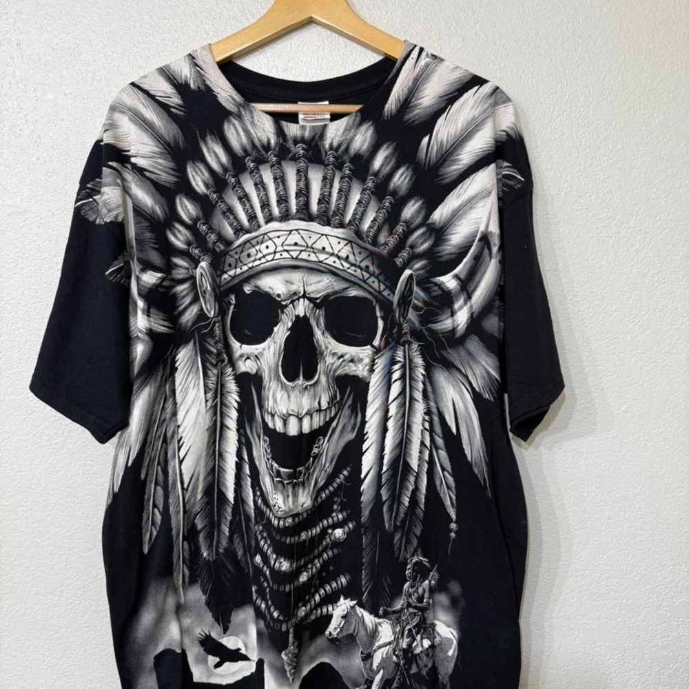 Black and white graphic tee with skull and feathers design